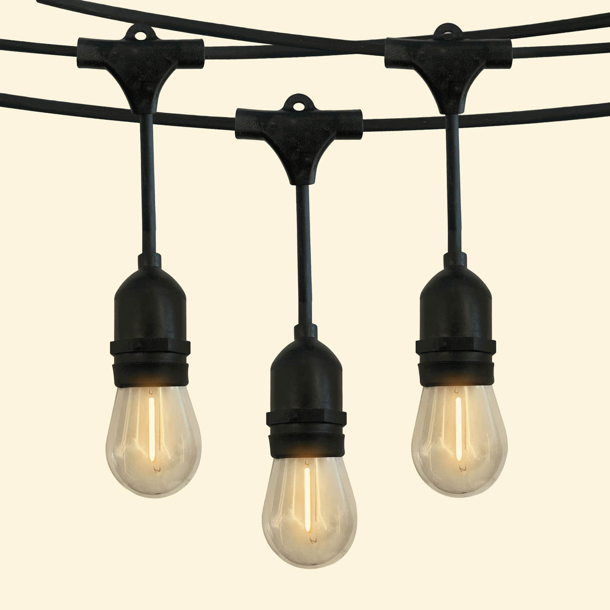 Guirlande lumineuse goutte avec ampoules LED à filament diffusant une lumière chaude, idéale pour une décoration extérieure élégante et conviviale.